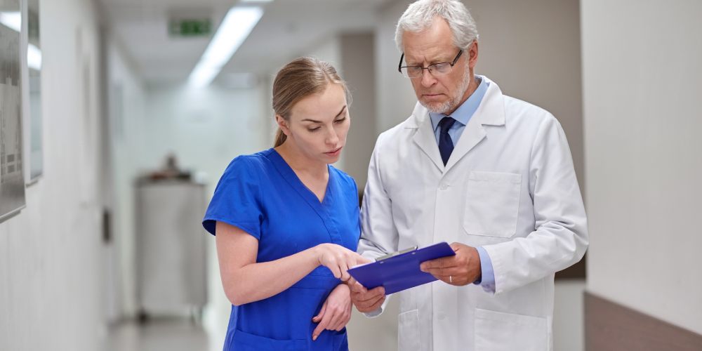 senior doctor and nurse with tablet pc at hospital